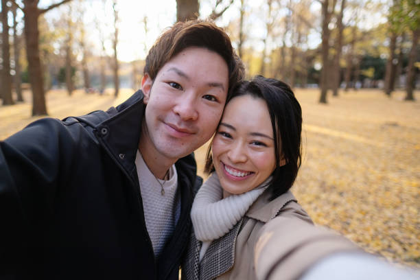 istock Couple taking selfie in park 1194803029
