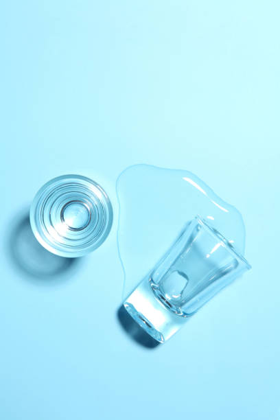 istock Vodka in shot glass on blue background with a blank space for a text 1194812589