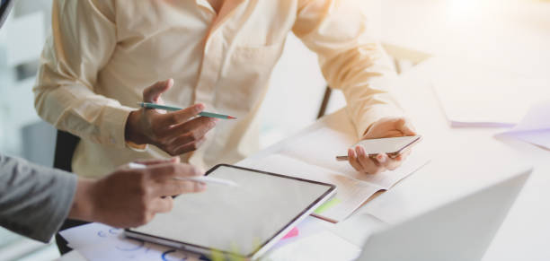 istock Cropped shot of two young businessmen working on their project while using tablet 1194812839