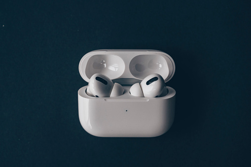 Wireless Apple AirPods headphones and charging case for Apple iPhone.