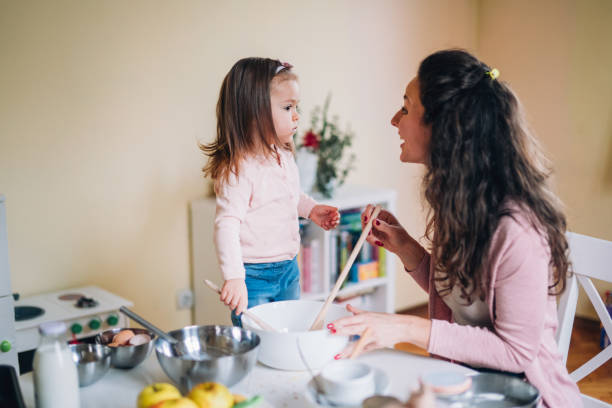 istock Happy mother and daughter in kitchen 1194817349