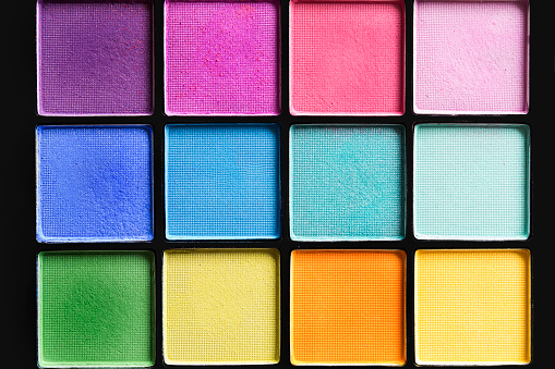 Colorful mat eyeshadows palette closeup as a background