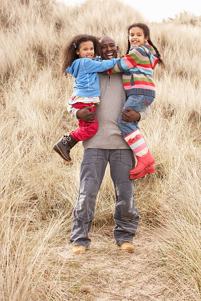 istock Father And Daughters Having Fun In Sand Dunes 119481837