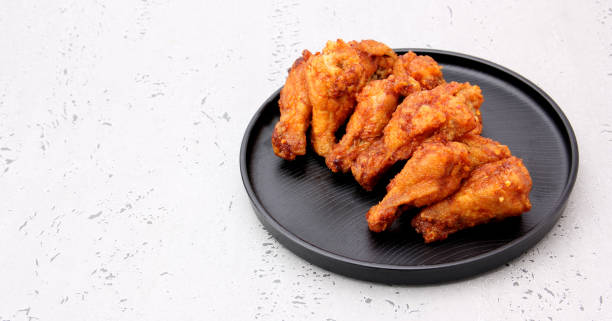 istock Korean fried chicken wings isolated on a gray background in studio. 1194818930