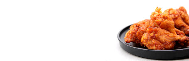 istock Close up to Korean fried chicken wings isolated on a white background in studio with copy space. 1194818931