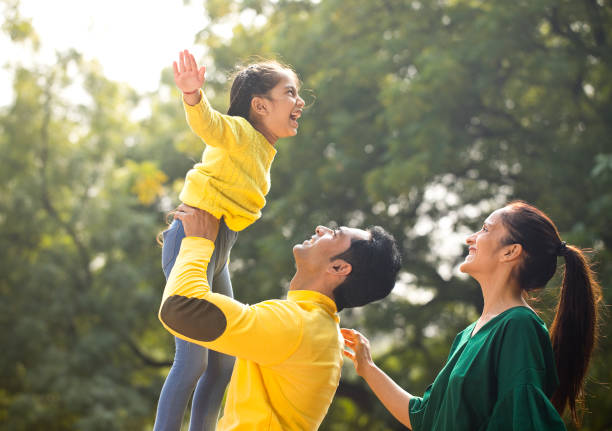 istock Indian family having fun at park 1194822211