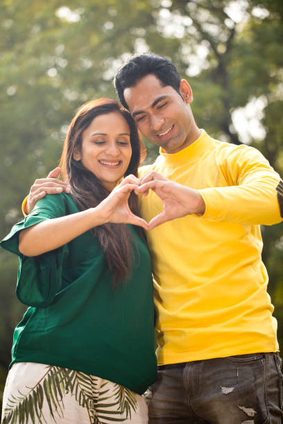 istock Couple making heart shape with their hands 1194822325