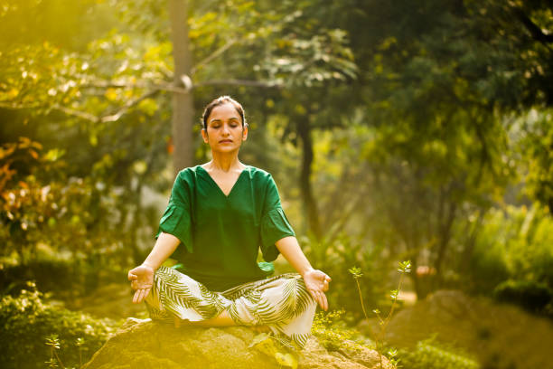 Yoga in Hampi temple copyspase at sunset.travel vacation copy spase lady with stylish jumpsuit