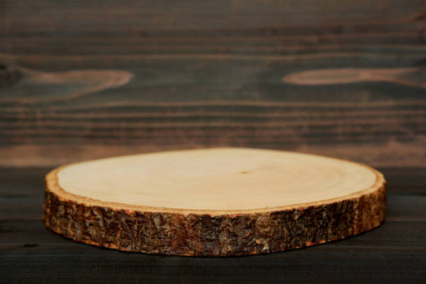 Rustic wooden slice serving board on wooden table.