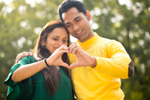 istock Couple making heart shape with their hands 1194829292