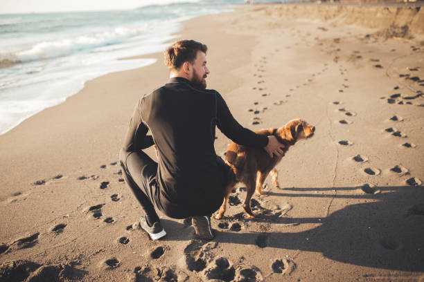istock Male runner is having some rest after morning jogging with his dog. He is using phone for a call and taking picture of his furry friends. 1194830031