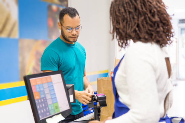 istock Focused young man paying bill in store 1194832401