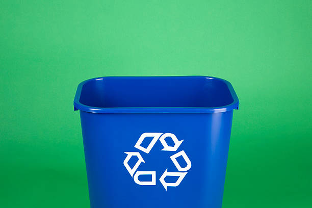 Recycling bin on green background with copy space stock photo