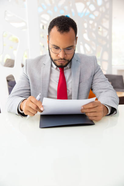 istock Serious businessman working with contract 1194832765