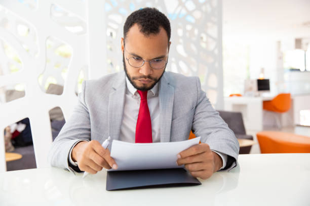 istock Serious businessman working with papers 1194833915