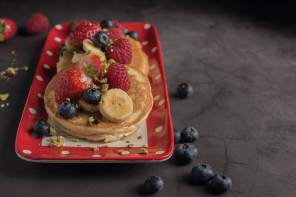 istock Pancakes with strawberries, banana and syrup with copyspace 1194834225