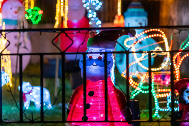 istock A variety of illuminated Christmas decorations viewed through a garden gate 1194835194