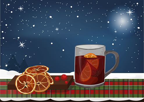 Christmas mulled wine with orange on the table with homes atmospher.