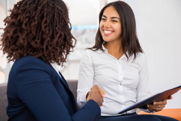 Cheerful businesswomen shaking hands