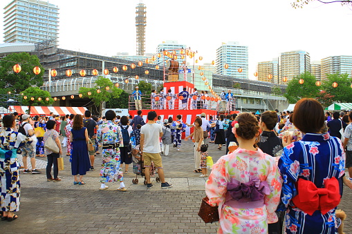 Yokohama, Japan - August 17th, 2018: Bon Odori festival, a major Japanese summer festival, held at a park in Yokohama. People celebrate by having a carnival and performing traditional Bon dance around a high wooden scaffold made especially for the festival called a yagura.