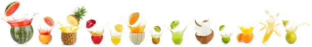 Photo of splashing fruit in a row on white background