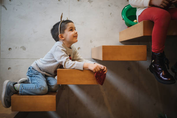 istock Cute little boy helps decorating a Christmas tree at home 1194838606