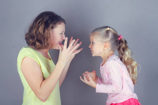 istock Two sisters quarrel, swear, argue and wave their arms. 1194838697