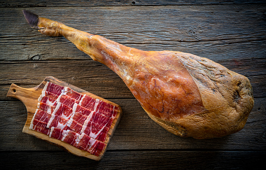 Iberian ham Iberic ham leg on rustic wood black hoof jamon iberico tapas