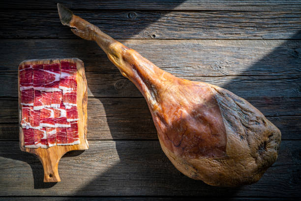 istock Iberian ham Iberic ham leg on rustic wood 1194838947