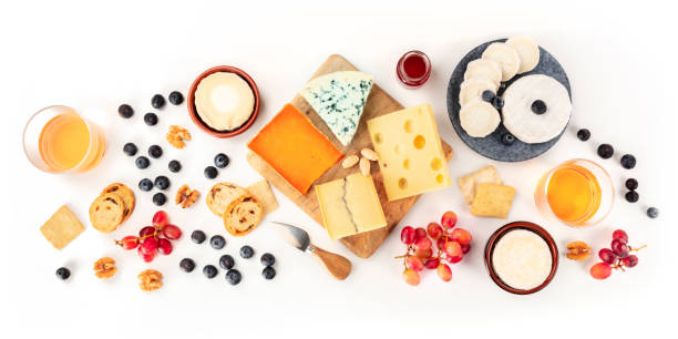 istock Cheese board, a flat lay panorama on a white background. Blue cheese, red Leicester, Emmental, goat cheese, Brie and others, shot from the top with wine and fruits 1194840133