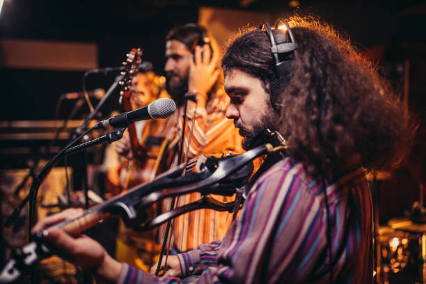 Group of people, men and woman musicians performing on stage together.