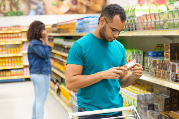 istock Focused African American man reading information on packaging 1194843228