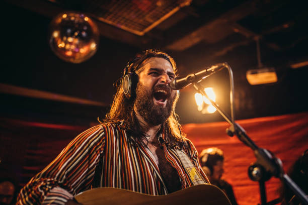 istock Man guitarist singing on stage 1194843281