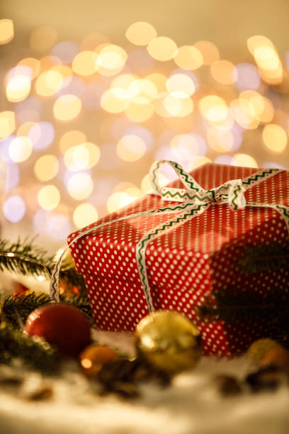 istock Golden fairy lights and a Christmas present 1194843337