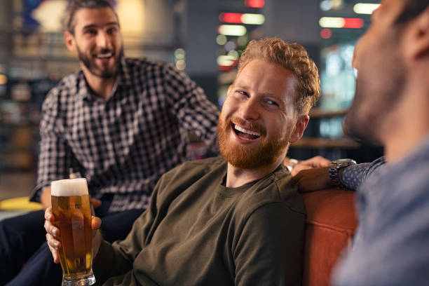 friends enjoying draft beer at pub - rustic beer brewery indoors imagens e fotografias de stock