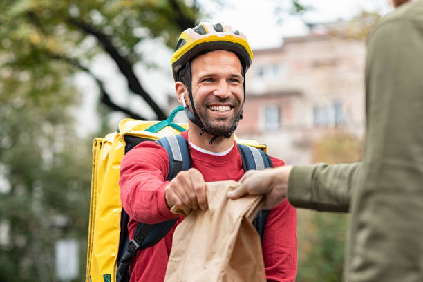 istock Delivery man giving take away food 1194844805