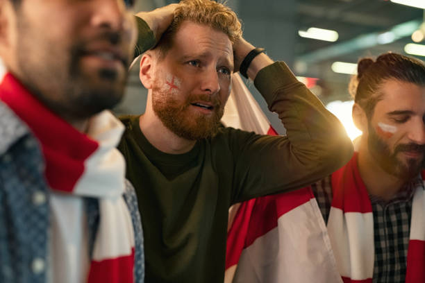 upset football fans watching their team - emotional stress looking group of people clothing imagens e fotografias de stock