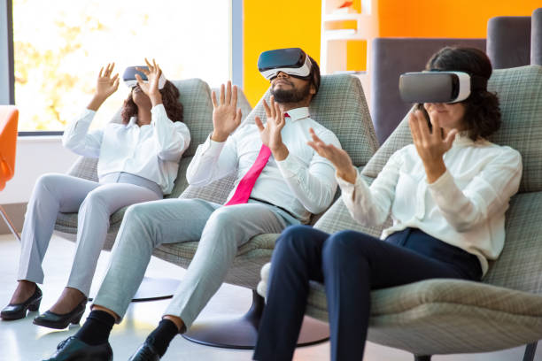 istock Multiethnic business people using VR headsets 1194847061