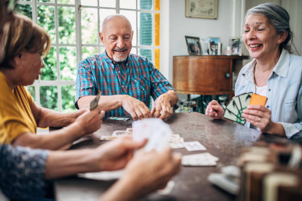 istock Senior friends playing cards 1194848529