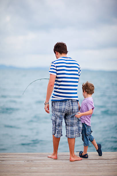 Son feeling surprised. Son feeling surprised and excited while seeing fish caught by father