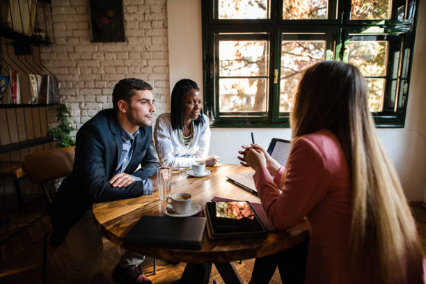 istock Young couple talking to financial advisor 1194849922