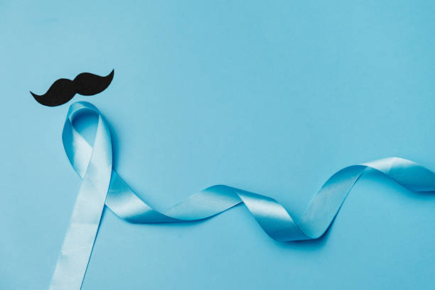 istock Top view on Light blue ribbon with mustache on blue background. Prostate Cancer Awareness, Movember Men's health awareness, November Blue, International Men's Day 1194850068