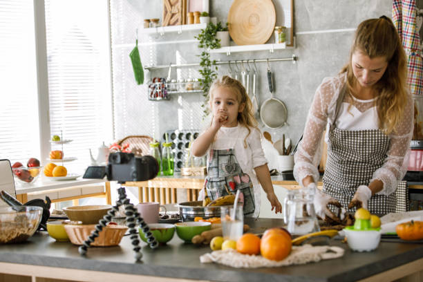istock Mother and daughter filming a video tutorial on how to make raw vegan cookies 1194851933