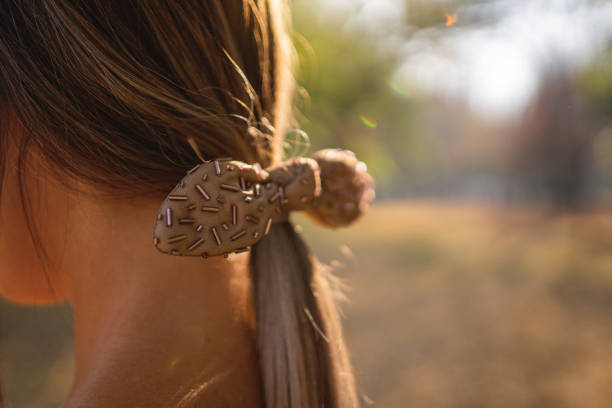 Cute girl with ponytail and hair bow outdoor.
