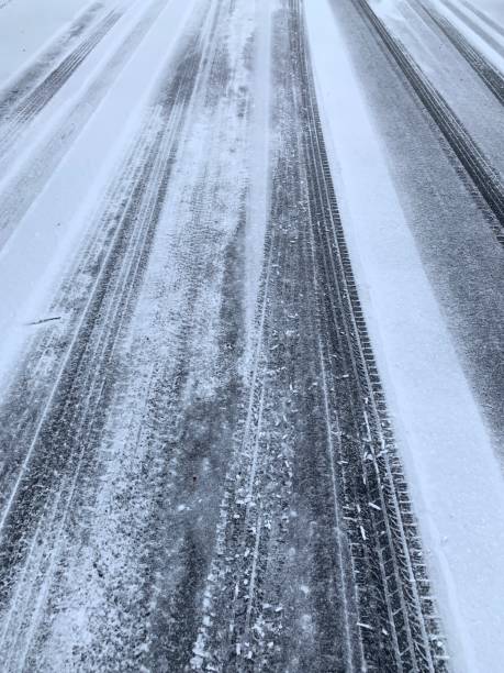 istock Tire Tracks on Snow Covered Road 1194853145
