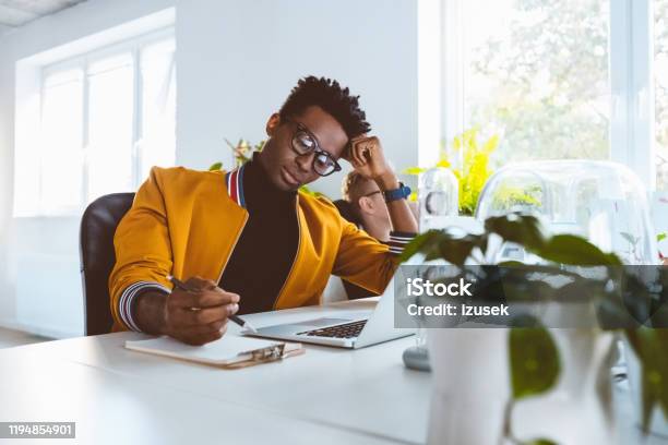 African Businessman Working At His Desk Stock Photo - Download Image Now - Making, Note - Message, Note Pad