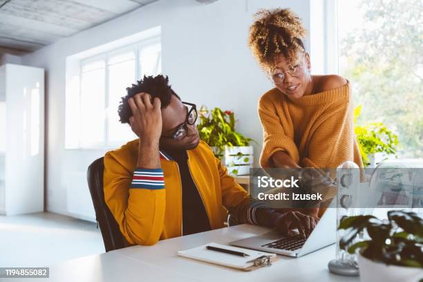Woman Helping Colleague In Office Stock Photo - Download Image Now - 30-34 Years, Adult, Adults Only