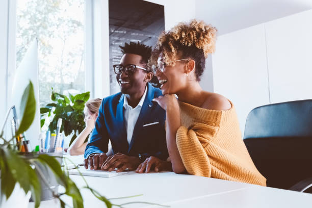 istock Two business professionals happily working in office 1194855307