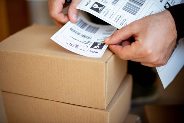 istock Delivery service, applying a shipping label 1194856132