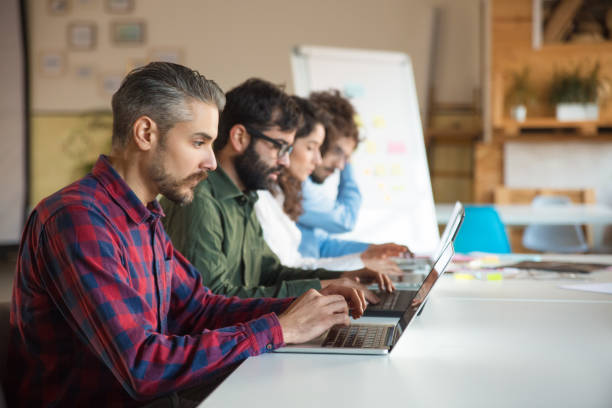 istock Startup team sitting at meeting table 1194859842